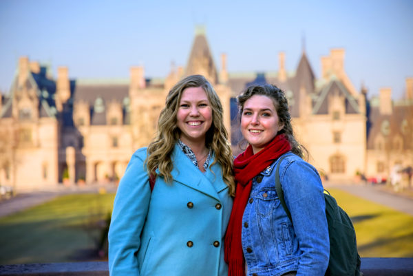 Women posing in front of the Biltmore at Christmas