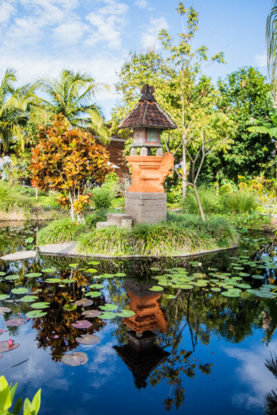 Orange sculpture on island in pond in Asian garden at Naples Botanical Gardens