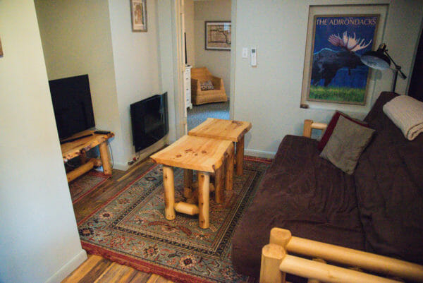 Interior of Airbnb in Plattsburgh, NY with brown couch and light wooden coffee tables