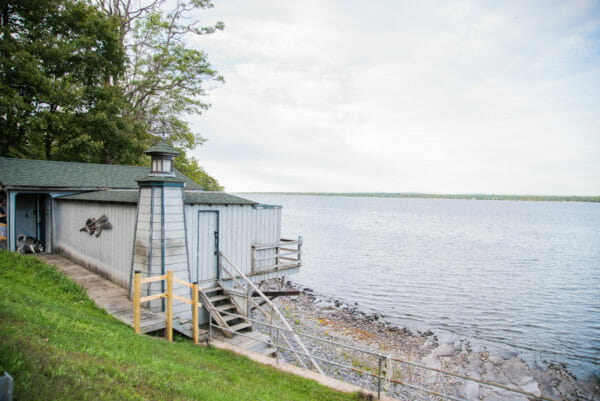 View of Lake Champlain with grey boat house and light