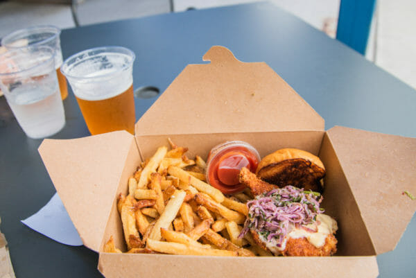 Fried chicken sandwich and French fries and beer at Zero Gravity brewery