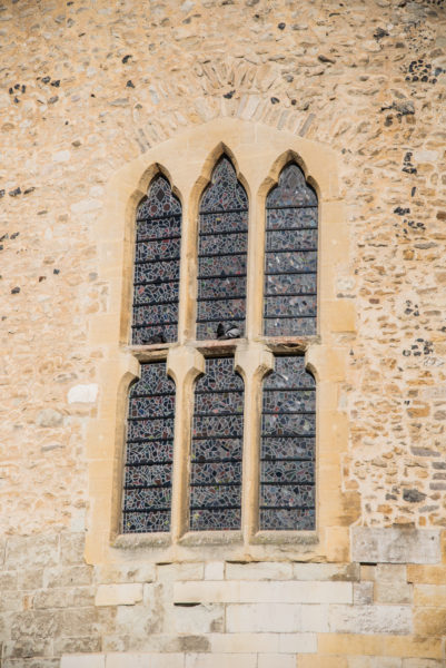 Set of three stained glass windows on a stone tower at the Tower of London