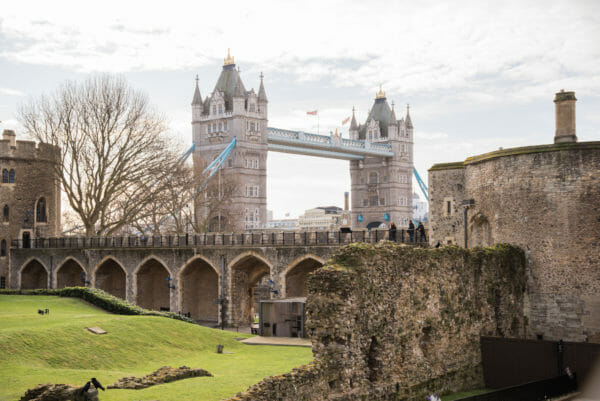 Tower Bridge behind a stone wall with arches
