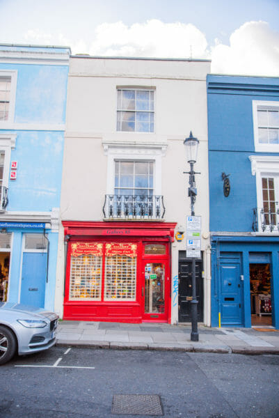 Store in Notting Hill with a red door and window frame