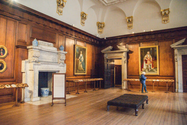 Hall in Hampton Court with paintings of kings on the walls