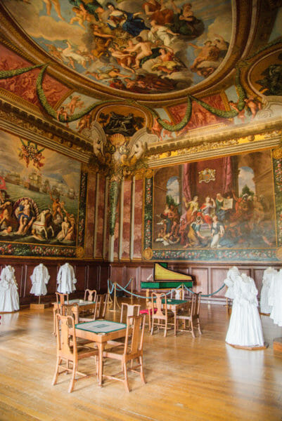 Room in Hampton Court with large paintings and painted ceiling