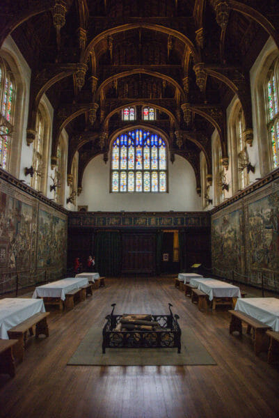 Dining hall with large stained glass windows at Hampton Court