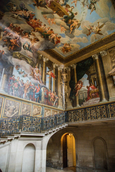 Large staircase with painted walls and ceiling at Hampton Court