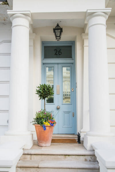 House with white columns and a blue door