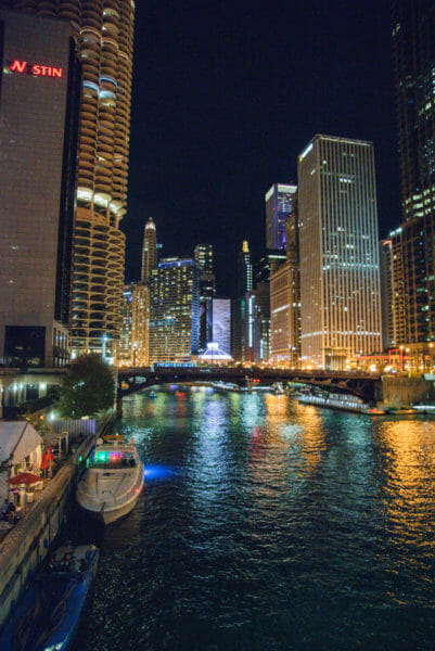 Boats on river in Chicago at night