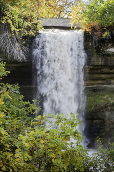 Minnehaha Falls behind trees with yellow leaves