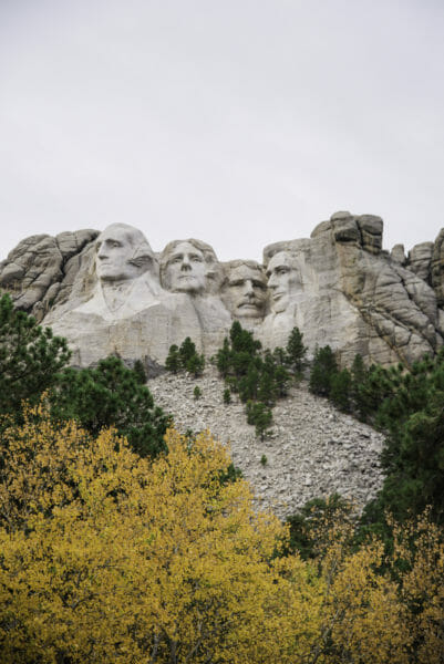 Mount Rushmore with trees with yellow leaves