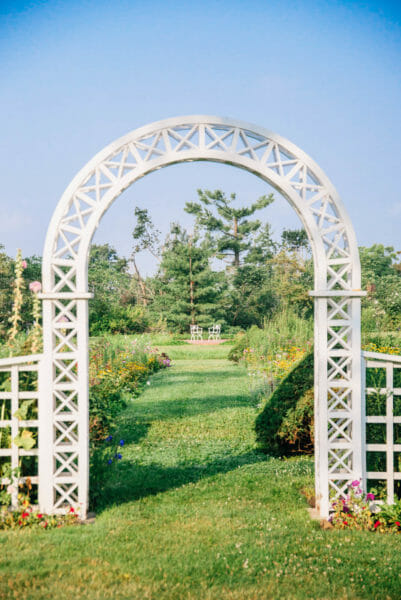 White archway in a garden