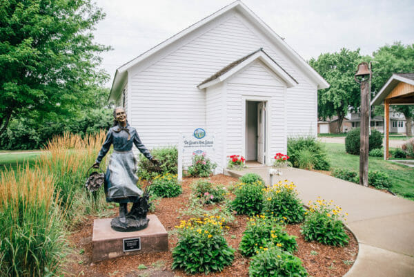 Laura Ingalls Wilder statue outside a white building